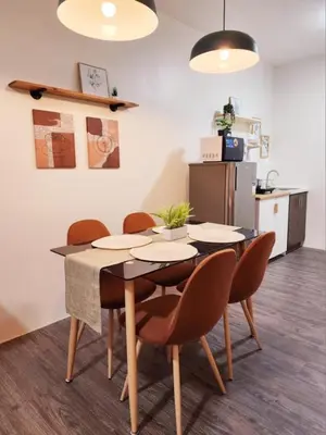 a dining room table and chairs in a kitchen at The Little Abode Nuvali - Smart Studio Unit with Balcony & free pool access in Calamba