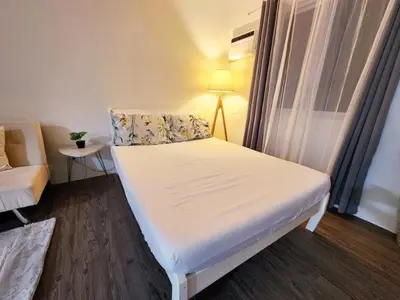 a small room with a bed and a window at The Little Abode Nuvali - Smart Studio Unit with Balcony & free pool access in Calamba