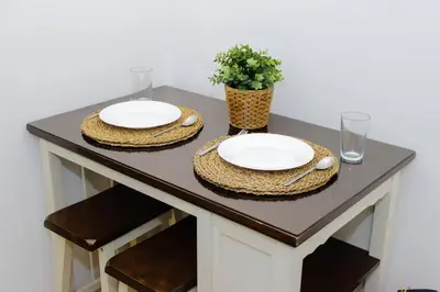 a table with two plates and a plant on it at Stars & Sunsets Sky Views 1br Iguazu Tower in Manila