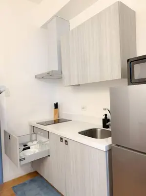 a white kitchen with a sink and a refrigerator at Stars & Sunsets Sky Views 1br Iguazu Tower in Manila