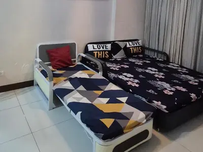 a bedroom with a bed and pillows on it at A&G Condotel at 101newport Near NAIA T3 in Manila