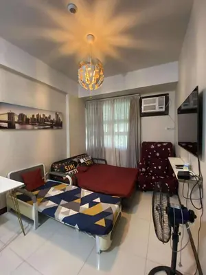 a living room with a bed and a couch at A&G Condotel at 101newport Near NAIA T3 in Manila