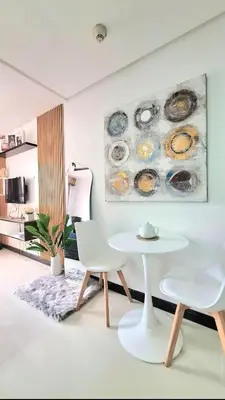 a living room with a table and two chairs at Cozy Staycation in Manila