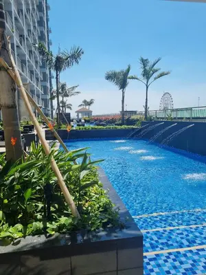 a swimming pool at a resort with palm trees at Condo With Water Views in Manila