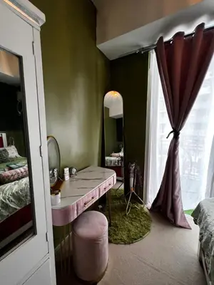 a bedroom with a dressing table and a mirror at Kasara Serenity Condotel in Manila