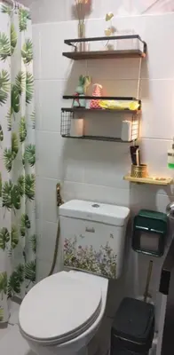 a bathroom with a toilet and a shower curtain at Kasara Serenity Condotel in Manila