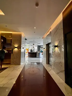 a lobby of a hotel with marble walls at Kasara Serenity Condotel in Manila