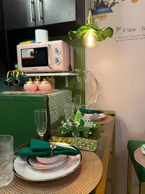 a table with plates and glasses on top of it at Kasara Serenity Condotel in Manila