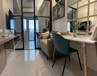 a living room with a table and a couch at Cozy Nook at Coast Residences in Manila