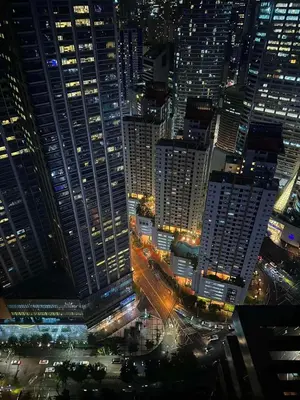 an aerial view of a city at night at Air Residences Suite by Christine Suites PH in Manila