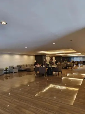 a lobby with couches and tables in a building at Air Residences Suite by Christine Suites PH in Manila