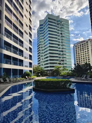 a pool in the middle of two tall buildings at Air Residences Suite by Christine Suites PH in Manila