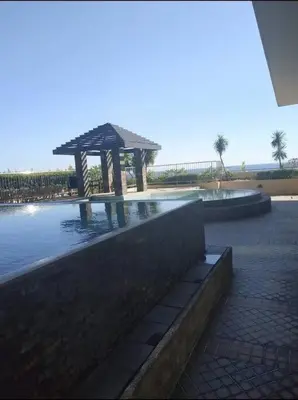 a swimming pool with a gazebo in the water at US Embassy, Cozy Condo, Ermita, Manila Roxas Blvd in Manila