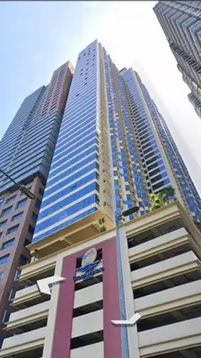 a tall building with blue windows on the side of it at US Embassy, Cozy Condo, Ermita, Manila Roxas Blvd in Manila