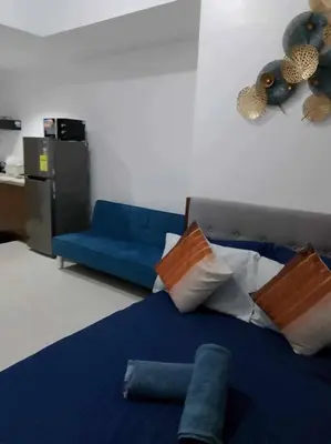 a bedroom with a blue bed and a blue couch at US Embassy, Cozy Condo, Ermita, Manila Roxas Blvd in Manila