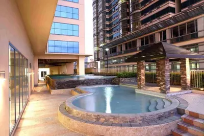 a swimming pool in a building with a building at US Embassy, Cozy Condo, Ermita, Manila Roxas Blvd in Manila