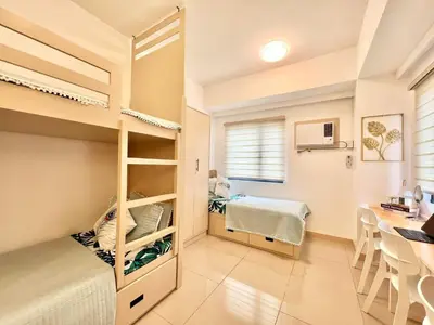 a bedroom with a bunk bed and a desk at La Casandrei in San Agustin