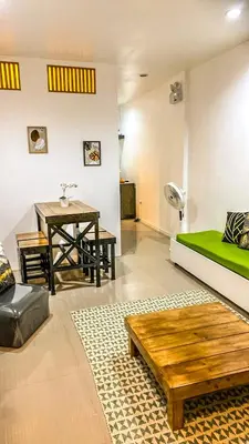 a living room with a bed and a table at FACE Transient Rooms in Kawit