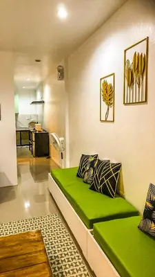 a room with a green bed in a room at FACE Transient Rooms in Kawit