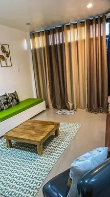 a living room with a couch and a coffee table at FACE Transient Rooms in Kawit