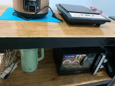 a desk with a phone and a box on it at FACE Transient Rooms in Kawit