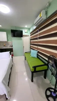 a room with a green bench in a room at FACE Transient Rooms in Kawit
