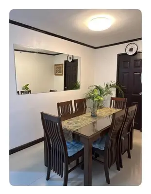 a dining room with a table and chairs and a mirror at Florie's Home in Santa Rosa