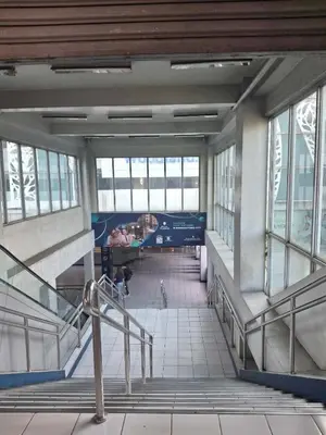 an empty lobby of a building with stairs and windows at Affordable Stay near BGC, Makati in Manila