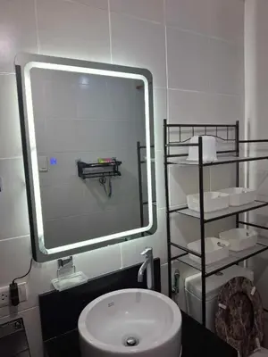 a bathroom with a mirror and a sink and a toilet at Affordable Stay near BGC, Makati in Manila
