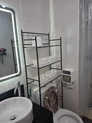 a bathroom with a white toilet and a sink at Affordable Stay near BGC, Makati in Manila