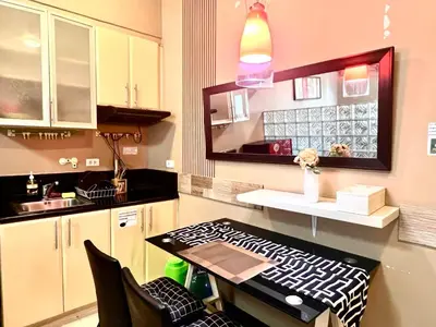a kitchen with a table and a counter top at BGC McKinley Apartment B1 in Manila