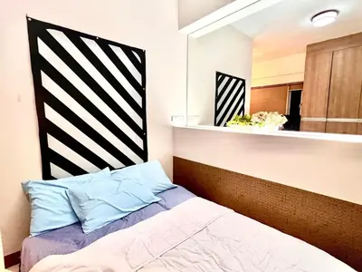 a bedroom with a bed and a mirror at Cozy Home in BGC McKinley B2 in Manila