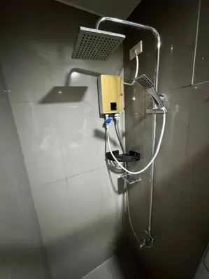 a shower in a public bathroom with a phone at Air Residences 43rdF -By Soliel in Manila