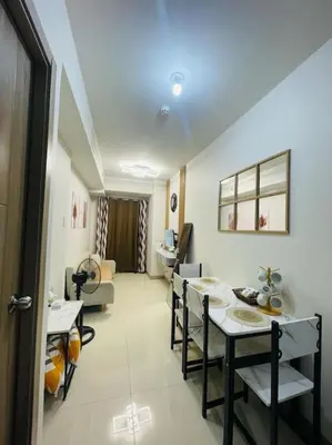 a room with a table and chairs and a living room at Juliš Apartment S residence- Moa complex pasay in Manila