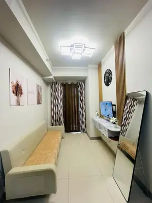 a room with a couch and a table and a window at Juliš Apartment S residence- Moa complex pasay in Manila