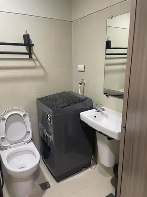 a small bathroom with a toilet and a sink at Juliš Apartment S residence- Moa complex pasay in Manila