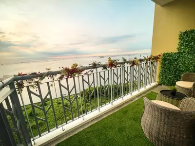 a balcony with a view of the ocean at Modern Luxury 4BR Manila Bay beside Okada Manila in Manila