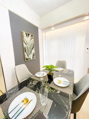 a dining room with a glass table and chairs at Modern Luxury 4BR Manila Bay beside Okada Manila in Manila
