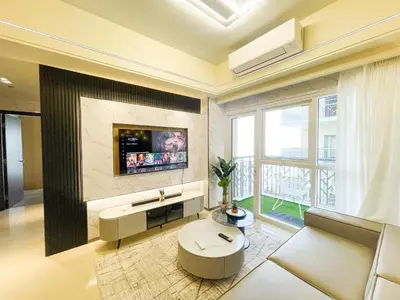 a living room with a tv on the wall at Modern Luxury 4BR Manila Bay beside Okada Manila in Manila