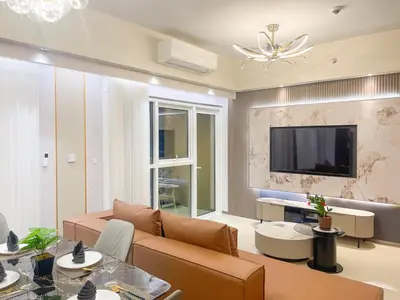 a living room with a couch and a tv at Luxurious 3BR in Manila Bay beside Okada in Manila