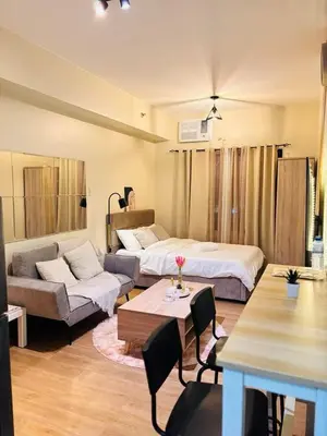 a living room with two beds and a couch at Fair bears accommodation in Manila