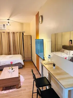 a hotel room with a bed and a desk and a room at Fair bears accommodation in Manila