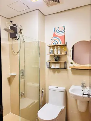 a bathroom with a shower and a toilet and a sink at Fair bears accommodation in Manila