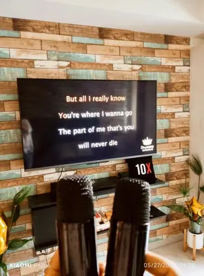 a wall made out of reclaimed wood with a flat screen tv at 225 St Tropez Tower Azure Urban Resort Residences in Manila