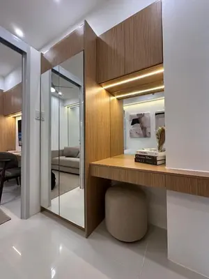 a room with a desk and a mirror at Antoneitte Staycation in Manila
