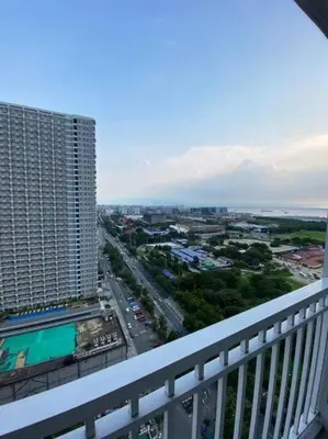 a view of a city from a balcony of a building at Breeze Residences 26th floor in Manila
