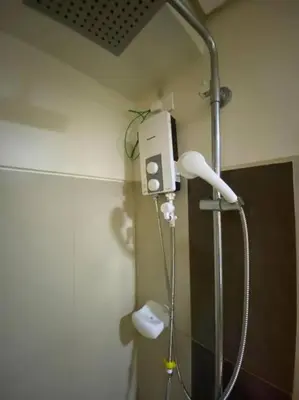 a shower in the corner of a bathroom at Breeze Residences 26th floor in Manila