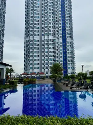 a large apartment building with a large building at La Casa Benice in Manila