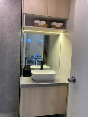 a bathroom with a sink and a mirror at La Casa Benice in Manila