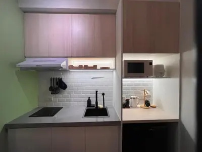 a small kitchen with a sink and a microwave at La Casa Benice in Manila